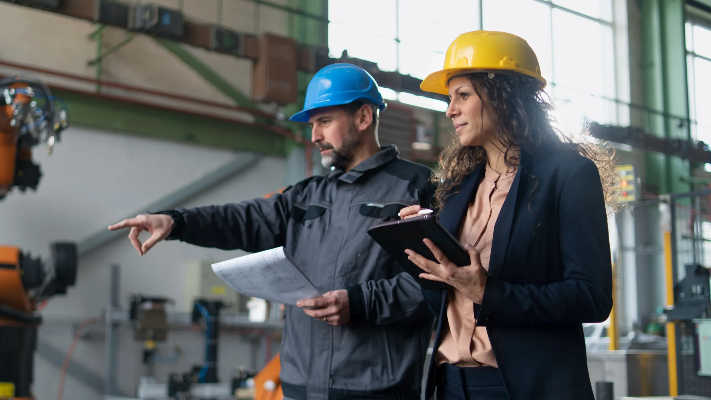 Woman and Man looking at Manufacturing equipment